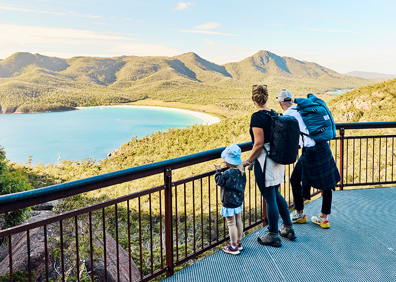 Worth the walk: Bushwalking young family in Tasmania, Australia taking in the view at Freycinet NP photo